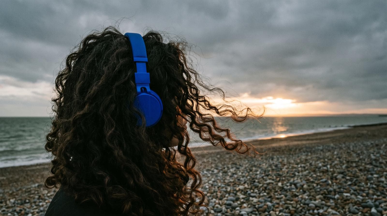 Headphones on the sand, facing the sea